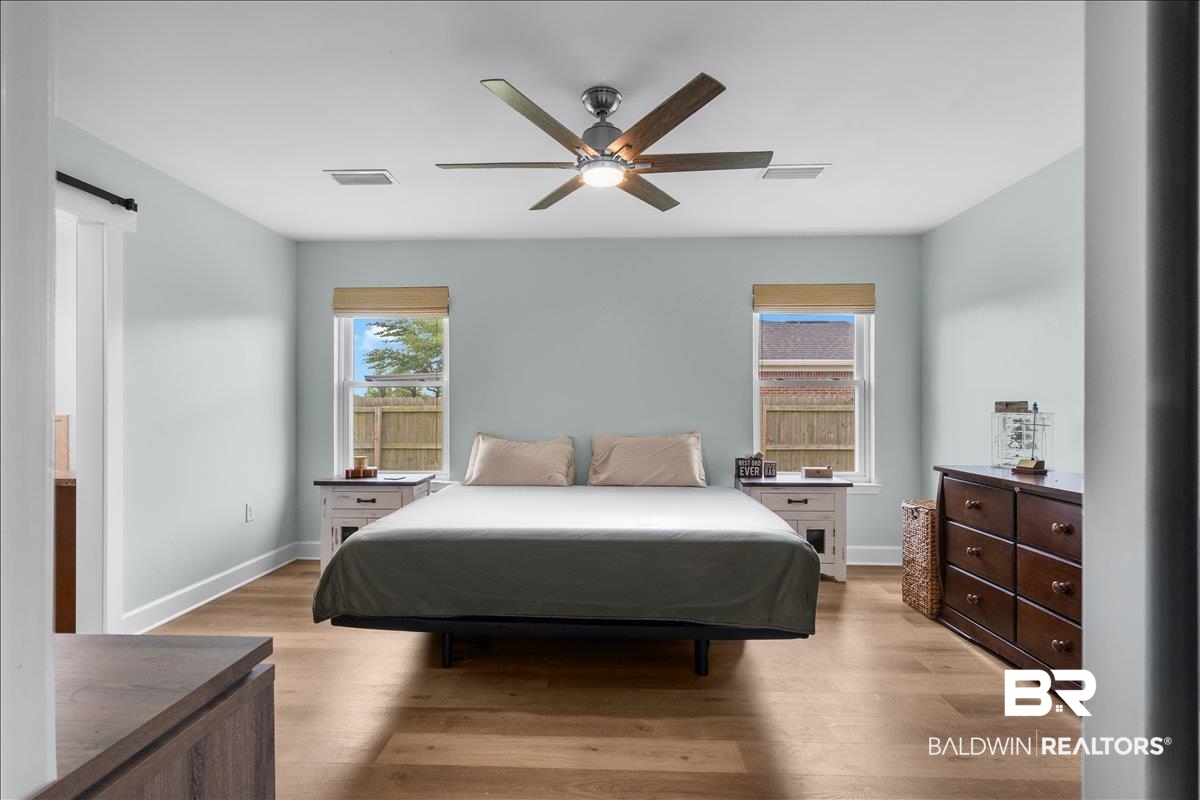8952 Sherman Road Foley, AL 36535 - Photo 23 of 41 Room featuring light blue walls, wood-finish flooring, and white baseboards