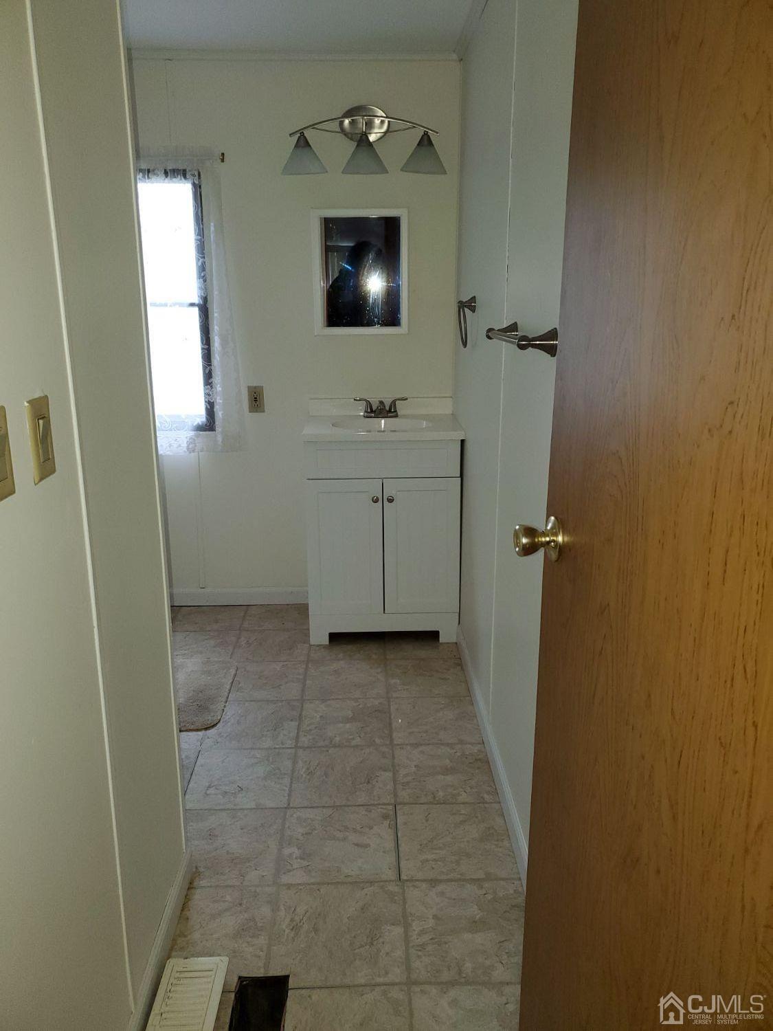 35 Dickens Road North Brunswick, NJ 08902 - Photo 9 of 15 a bathroom with a sink a toilet and mirror