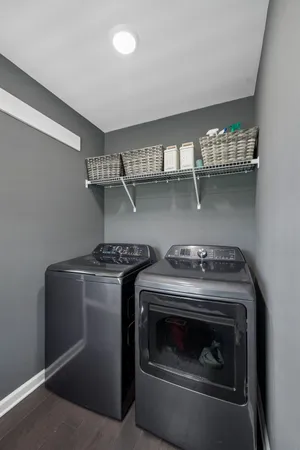 a bedroom with bed and a flat tv screen on dresser