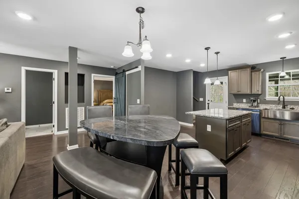 a kitchen with stainless steel appliances granite countertop a sink stove microwave and cabinets