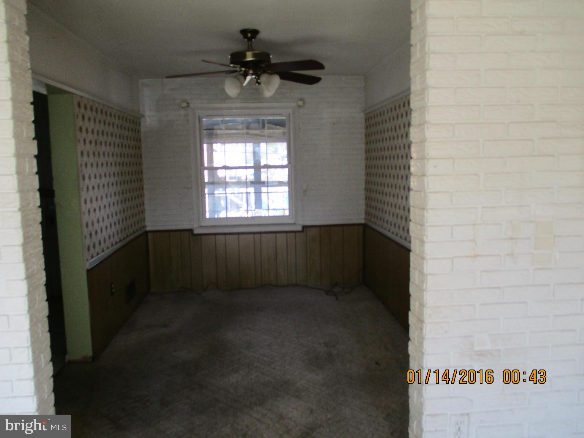 2706 Norfen Road Baltimore, MD 21227 - Photo 3 of 10 a view of an empty room and a window