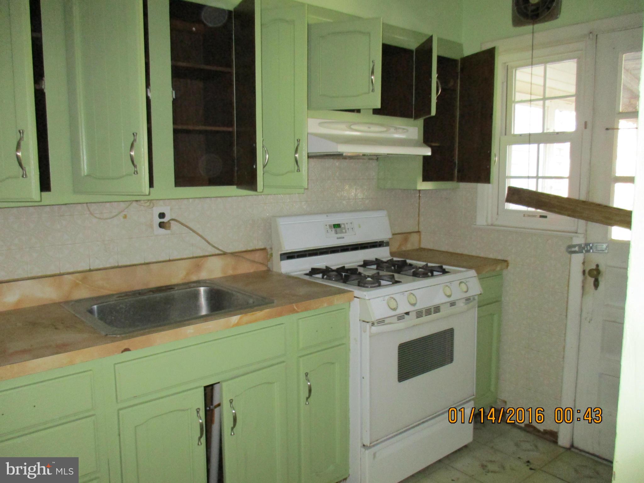 2706 Norfen Road Baltimore, MD 21227 - Photo 4 of 10 a kitchen with a stove and a sink