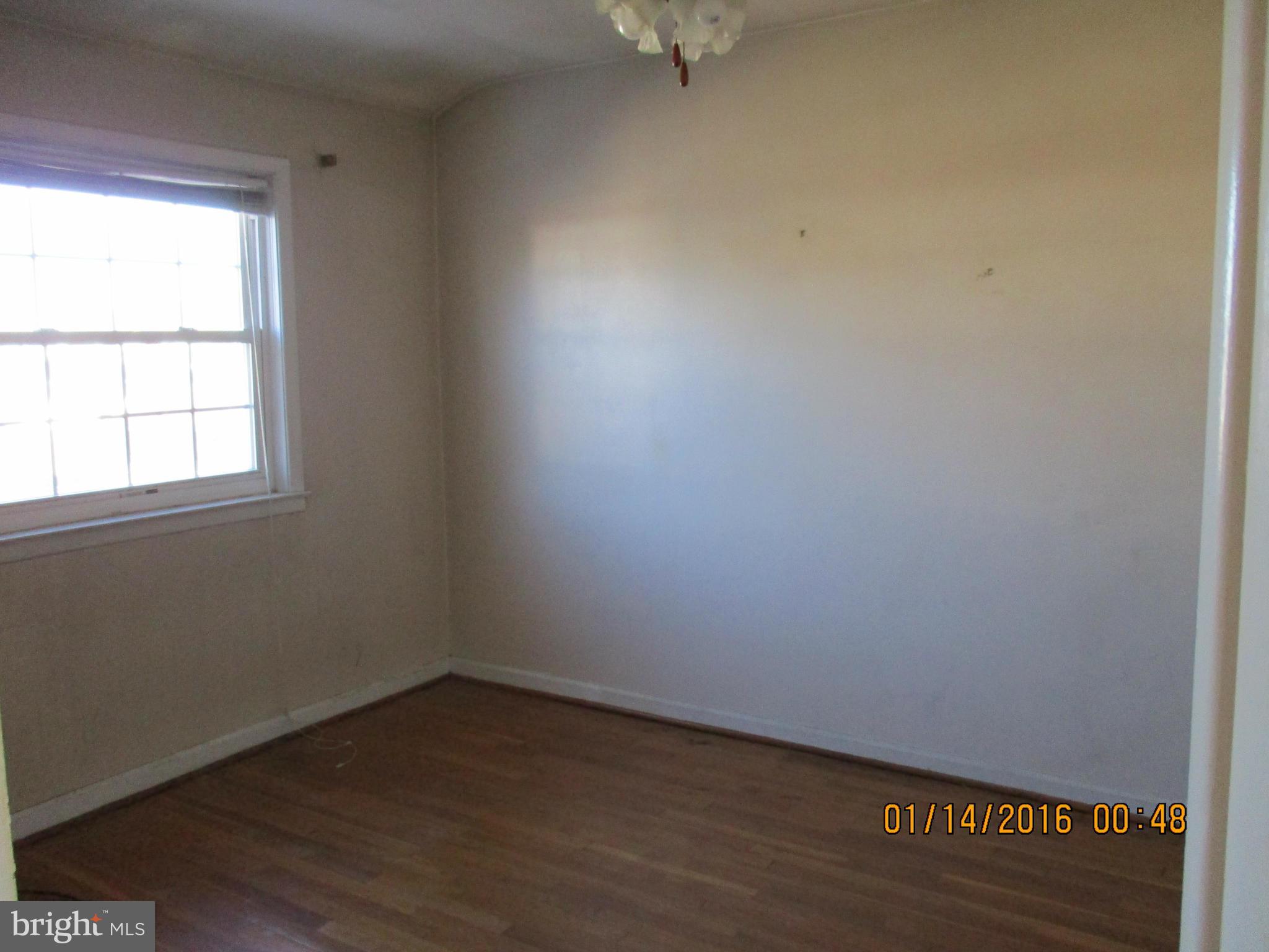 2706 Norfen Road Baltimore, MD 21227 - Photo 7 of 10 an empty room with a window