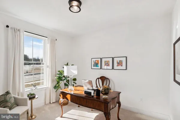 a view of a workspace with a window and couch