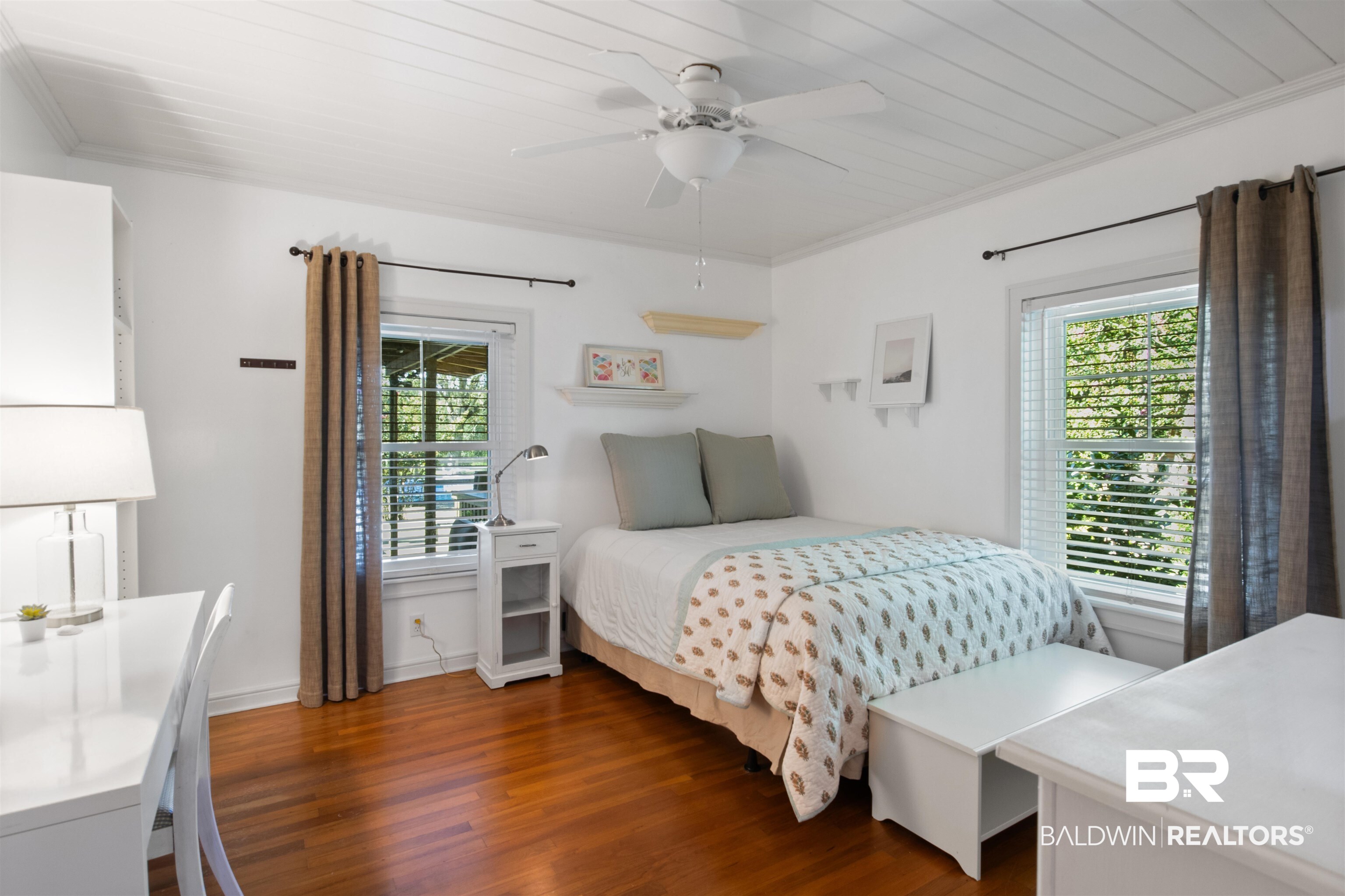 15100 Vasko Road Silverhill, AL 36576 - Photo 22 of 51 Bedroom featuring ornamental molding, new double paned, impact resistant windows, wood flooring, and ceiling fan. Overlooks porch and hot tub.