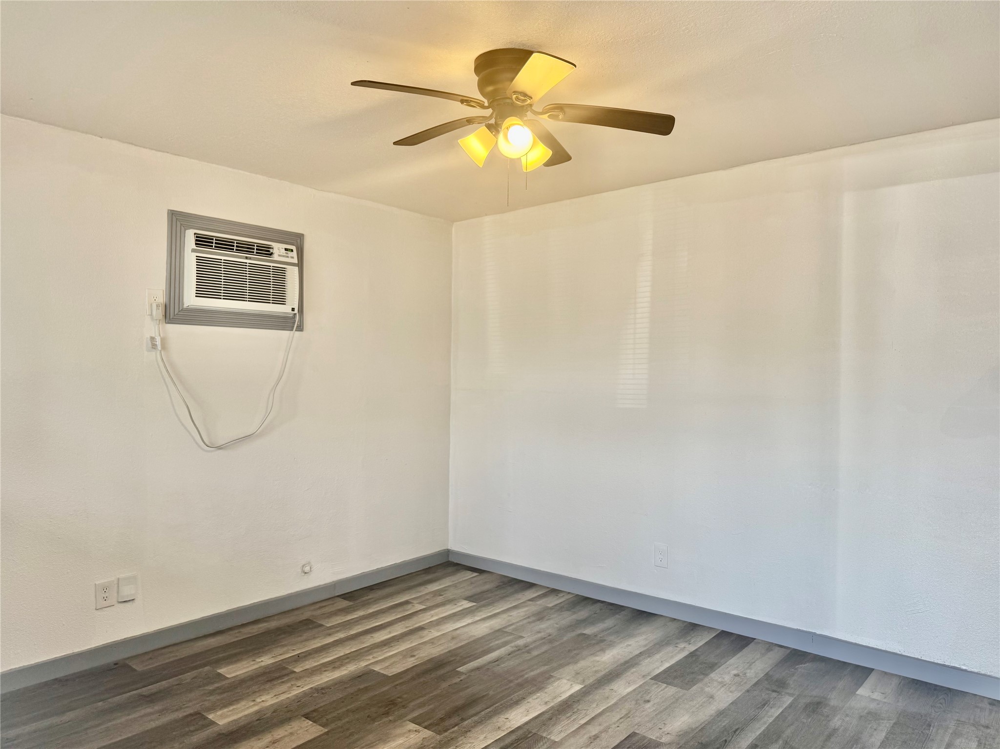 1001 Spooner Street, Unit C Pasadena, TX 77506 - Photo 2 of 9 a view of a room with a window and a ceiling fan