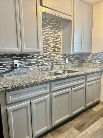 a stove top oven sitting inside of a kitchen