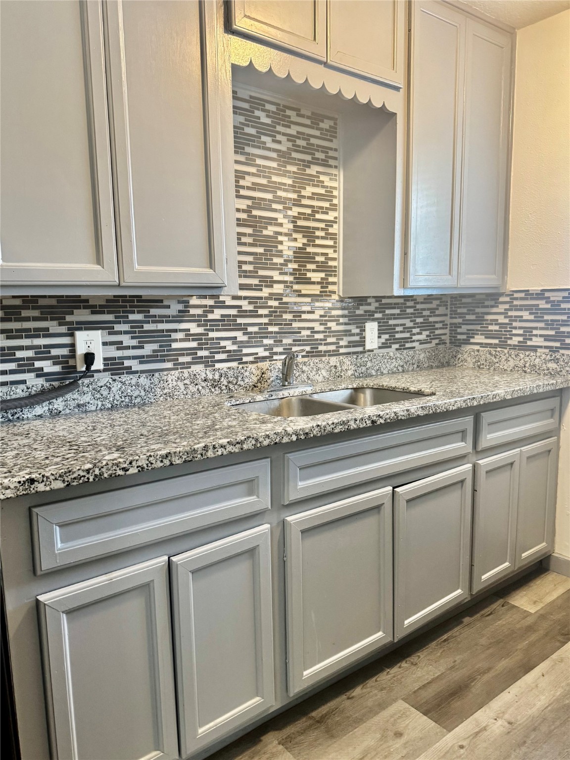 1001 Spooner Street, Unit C Pasadena, TX 77506 - Photo 5 of 9 a sink with granite countertop cabinets