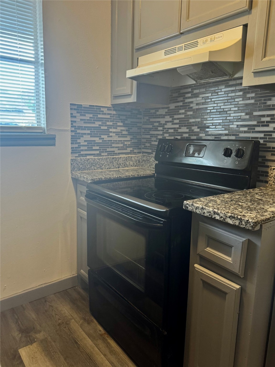 1001 Spooner Street, Unit C Pasadena, TX 77506 - Photo 6 of 9 a stove top oven sitting inside of a kitchen