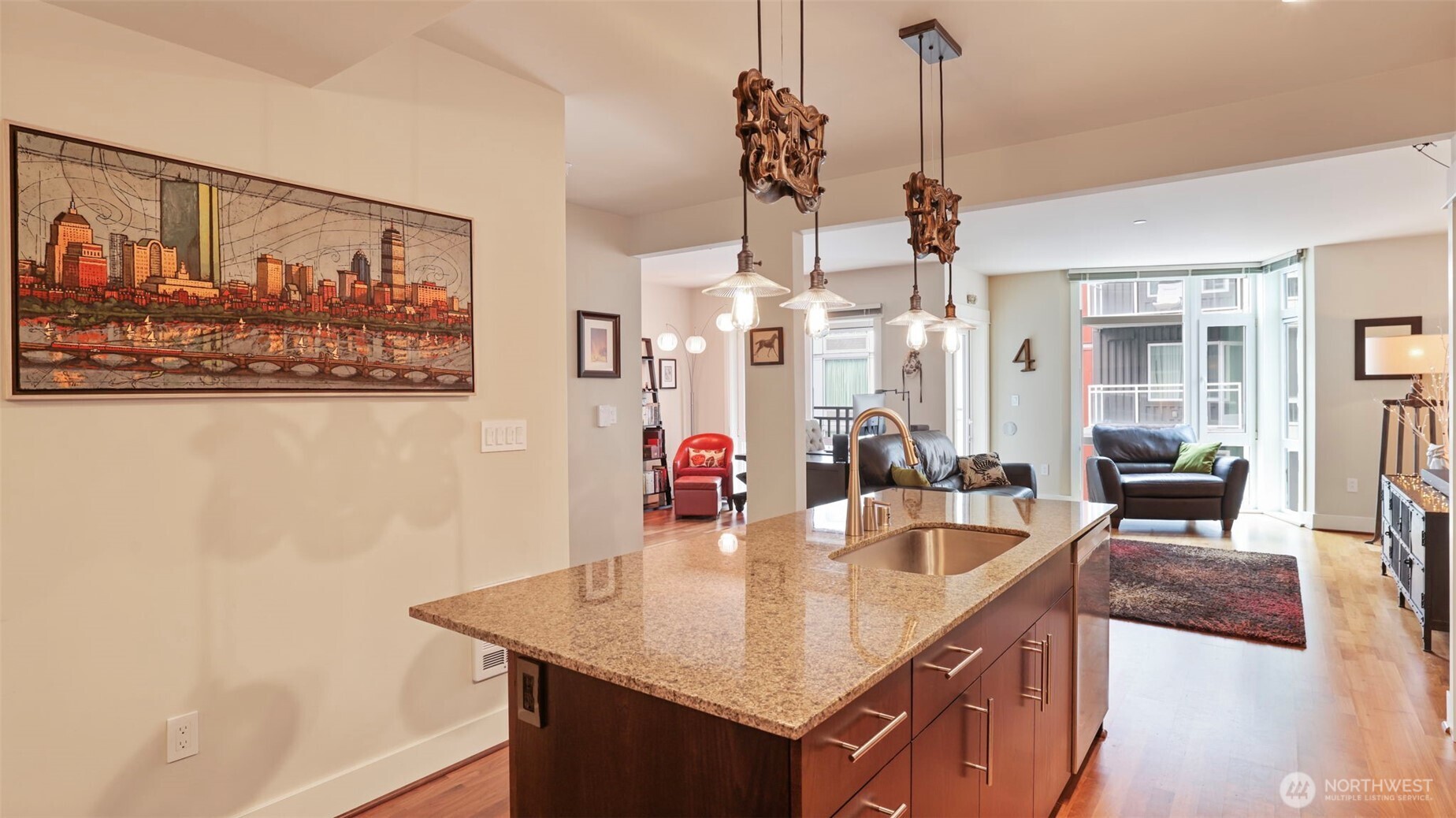 699 John Street, Unit 513 Seattle, WA 98109 - Photo 4 of 33 a kitchen with stainless steel appliances granite countertop a sink and a wooden floor