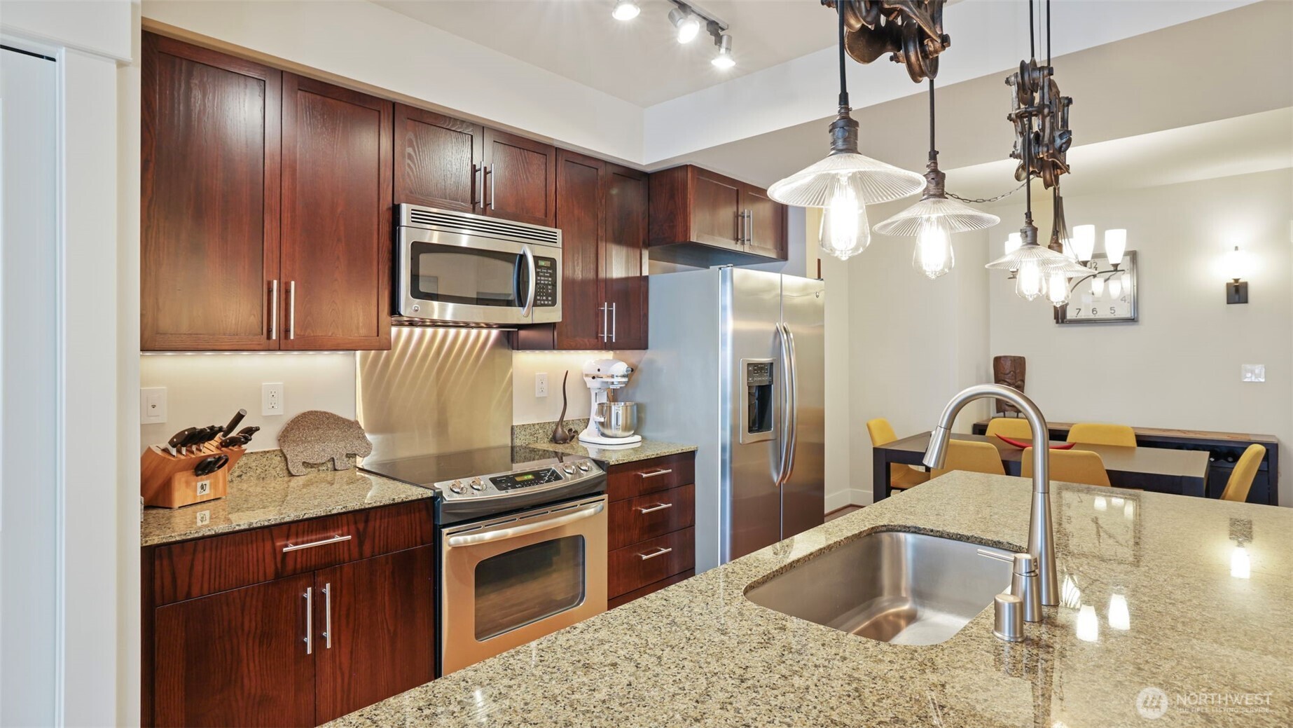 699 John Street, Unit 513 Seattle, WA 98109 - Photo 6 of 33 a kitchen with stainless steel appliances granite countertop a sink a stove and refrigerator