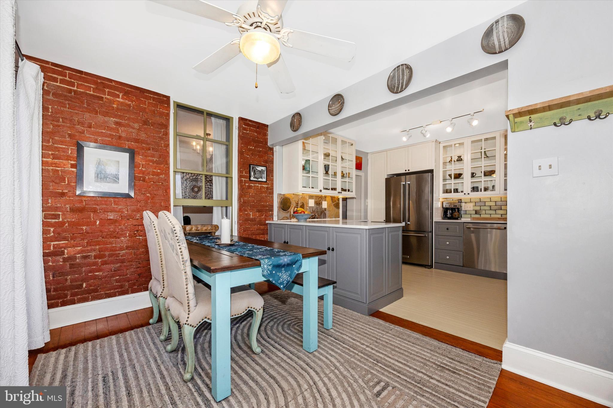 73 West Main Street New Market, MD 21774 - Photo 20 of 44 a kitchen with stainless steel appliances a dining table chairs and a refrigerator