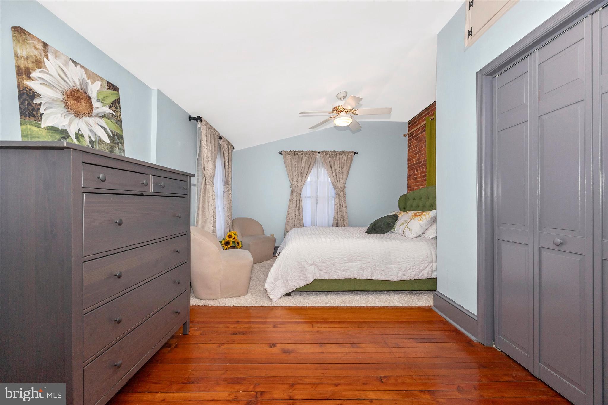 73 West Main Street New Market, MD 21774 - Photo 23 of 44 a bedroom with a bed and lamp with dresser