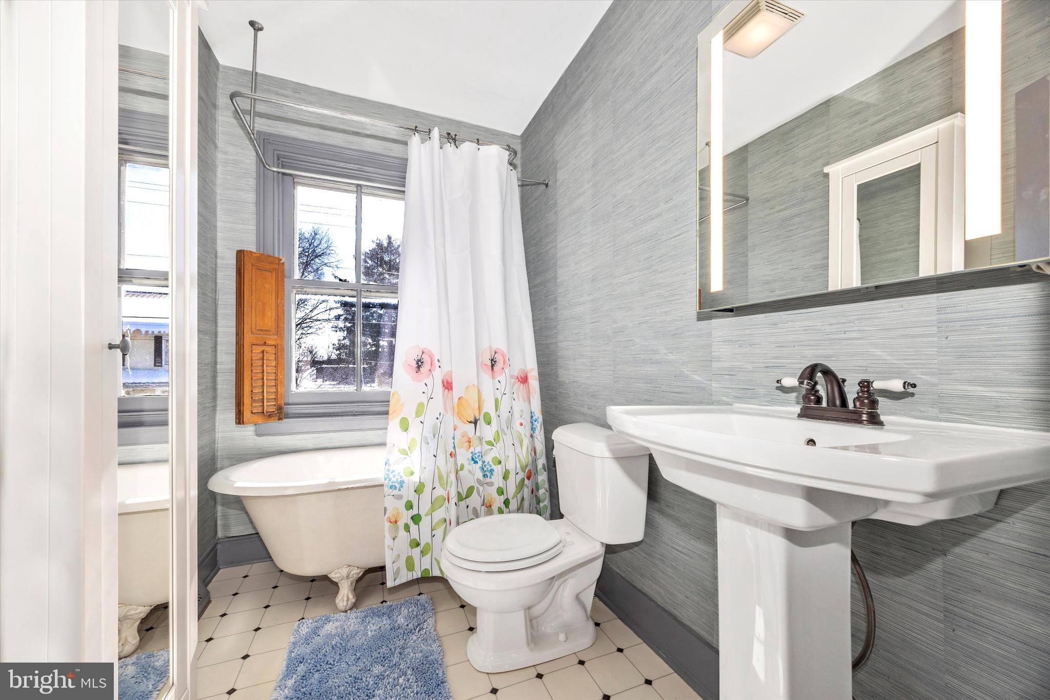 73 West Main Street New Market, MD 21774 - Photo 26 of 44 a bathroom with a sink toilet mirror and shower