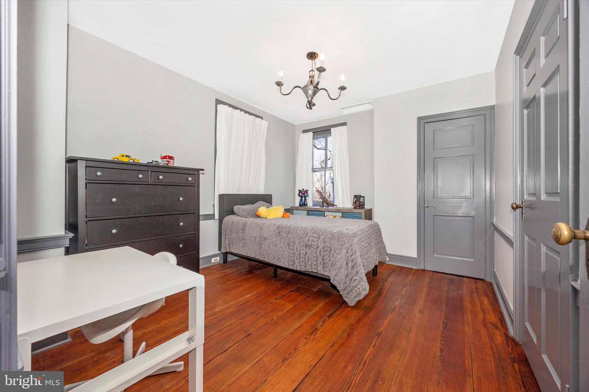 73 West Main Street New Market, MD 21774 - Photo 28 of 44 a bedroom with a bed and wooden floor