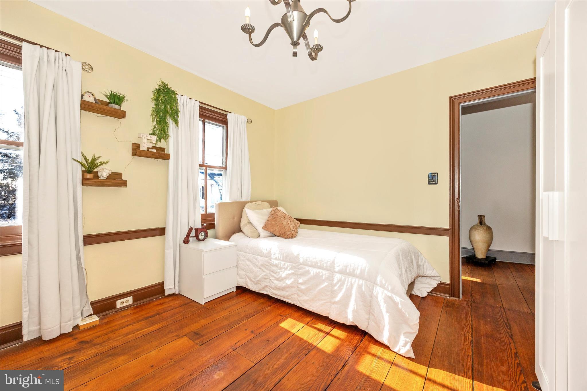 73 West Main Street New Market, MD 21774 - Photo 29 of 44 a bedroom with a bed and a large mirror