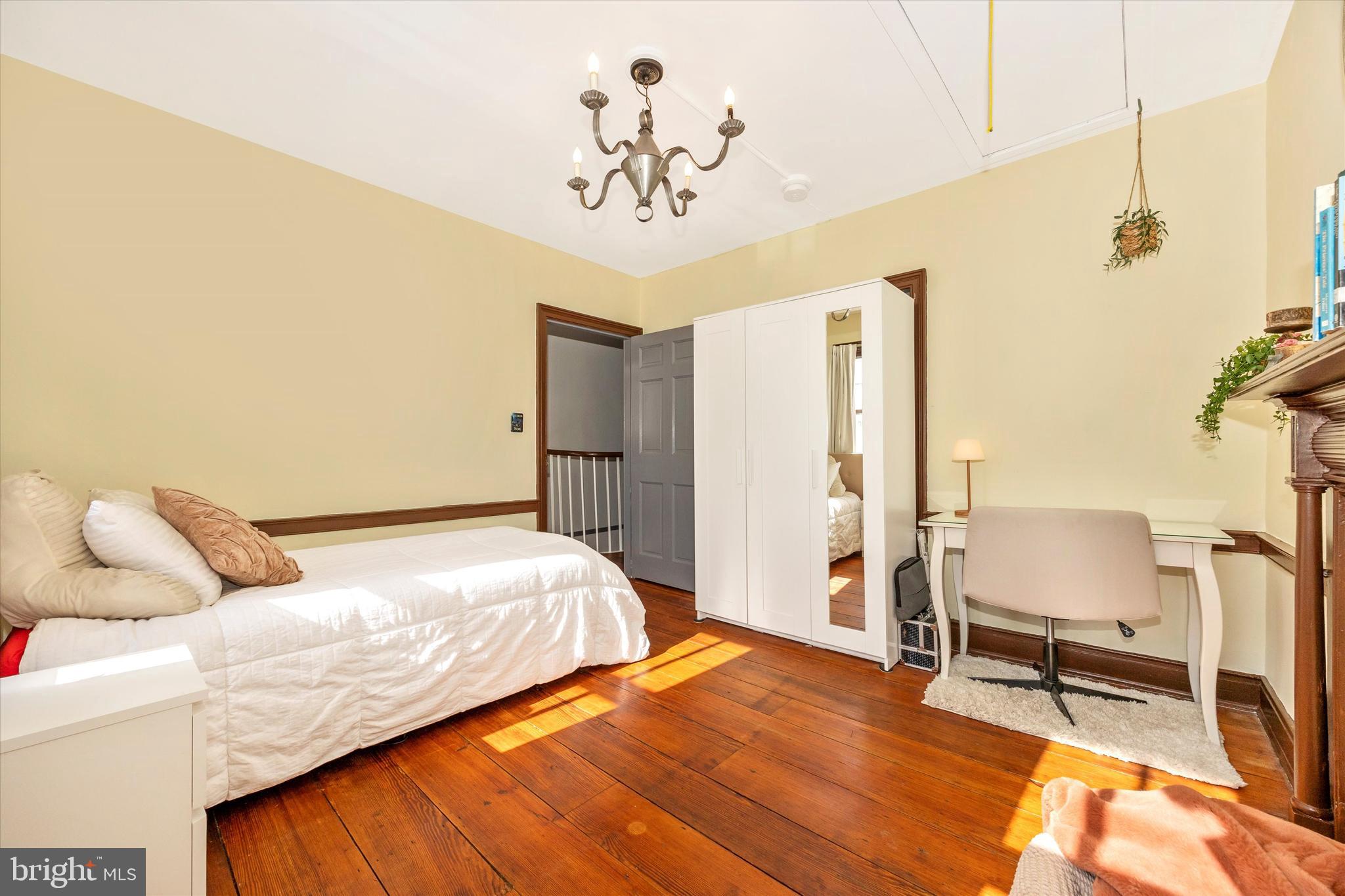 73 West Main Street New Market, MD 21774 - Photo 31 of 44 a bedroom with a bed and a chandelier