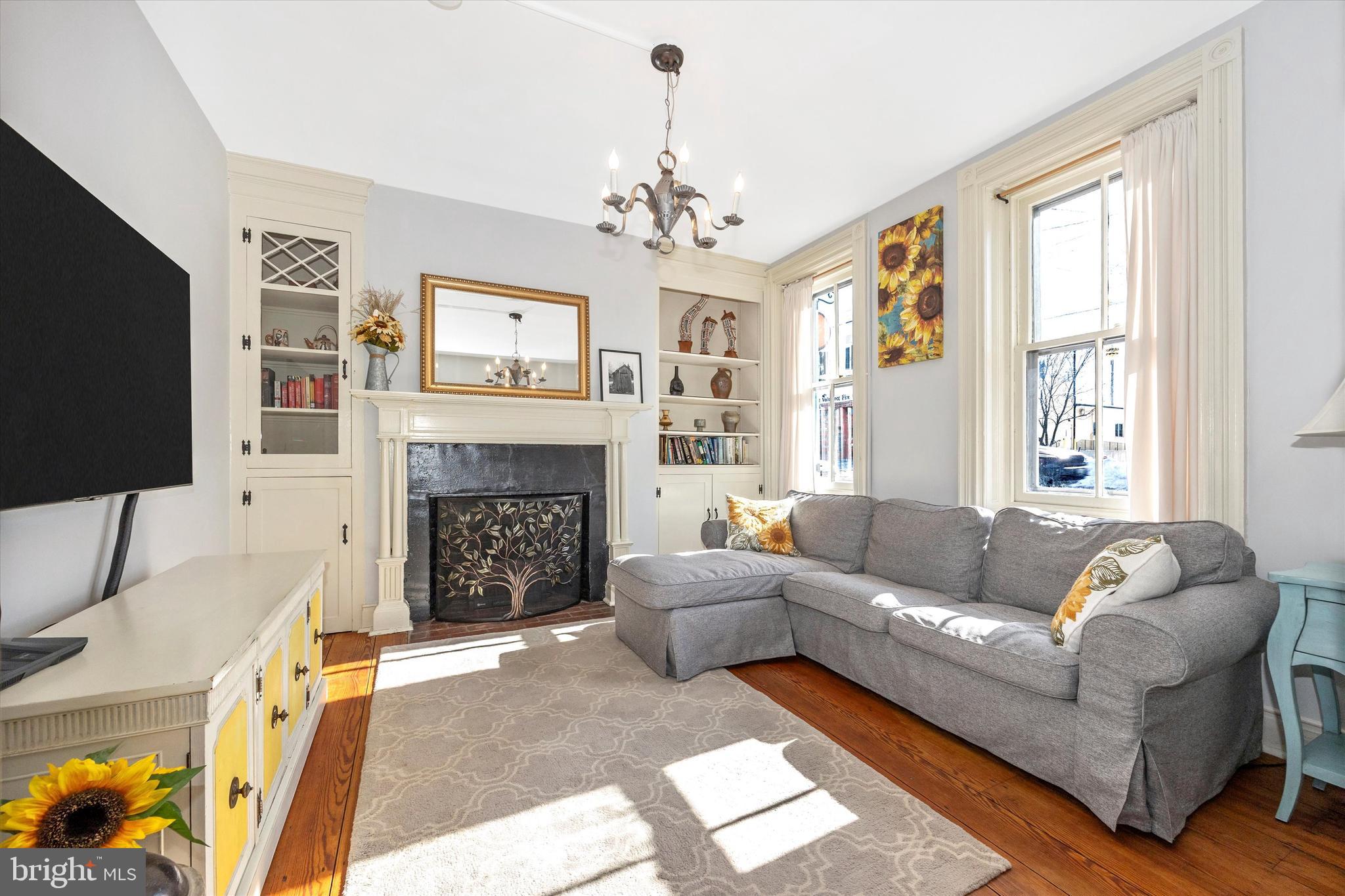 73 West Main Street New Market, MD 21774 - Photo 9 of 44 a living room with furniture a fireplace and a flat screen tv
