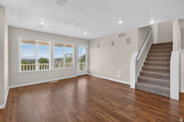 1305 Alpine Way Provo, UT 84606 - Photo 5 of 56 Wood-finish flooring throughout, multiple windows, recessed ceiling lights, and a carpeted staircase