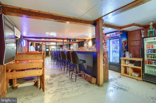 a room with table tennis pool table and a large window