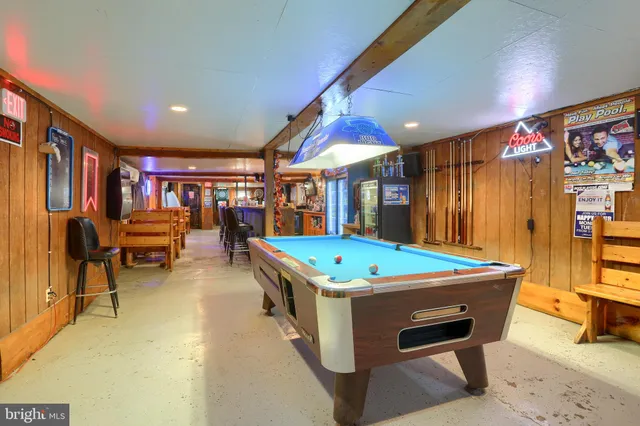 a room with pool table and windows