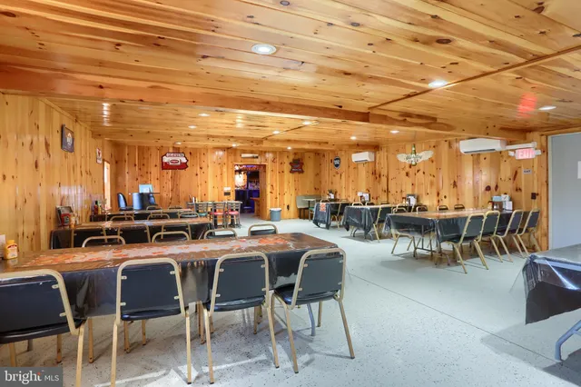 a view of a dining room with furniture and a fireplace