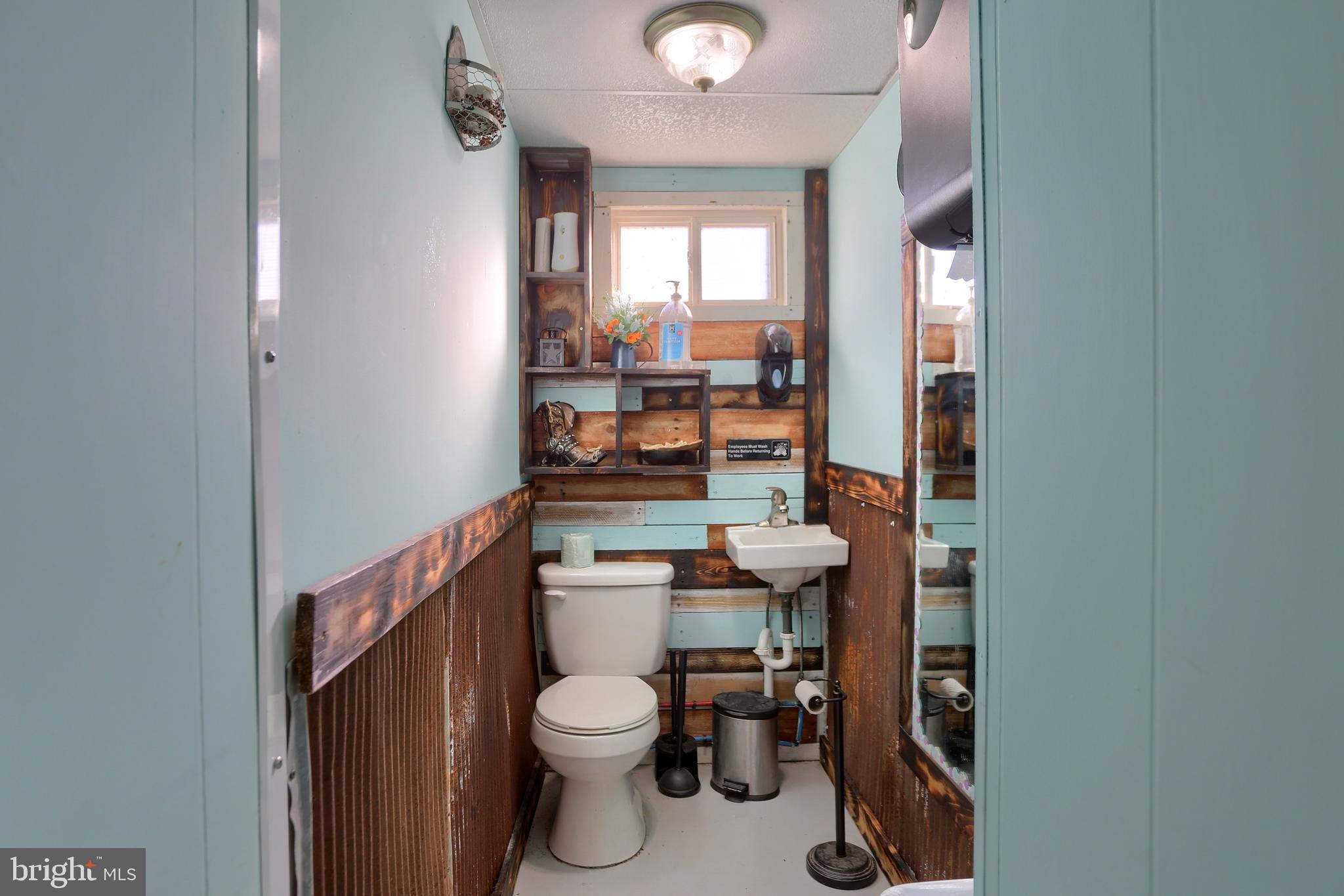 3095 Turkey Valley Road Mount Pleasant Mills, PA 17853 - Photo 23 of 55 a bathroom with a toilet a sink and a window