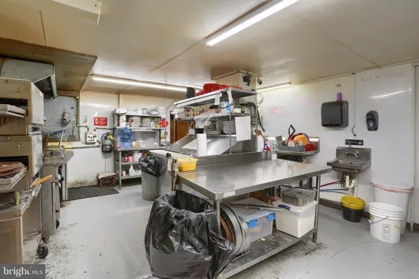 a kitchen with stainless steel appliances granite countertop a stove refrigerator and a sink