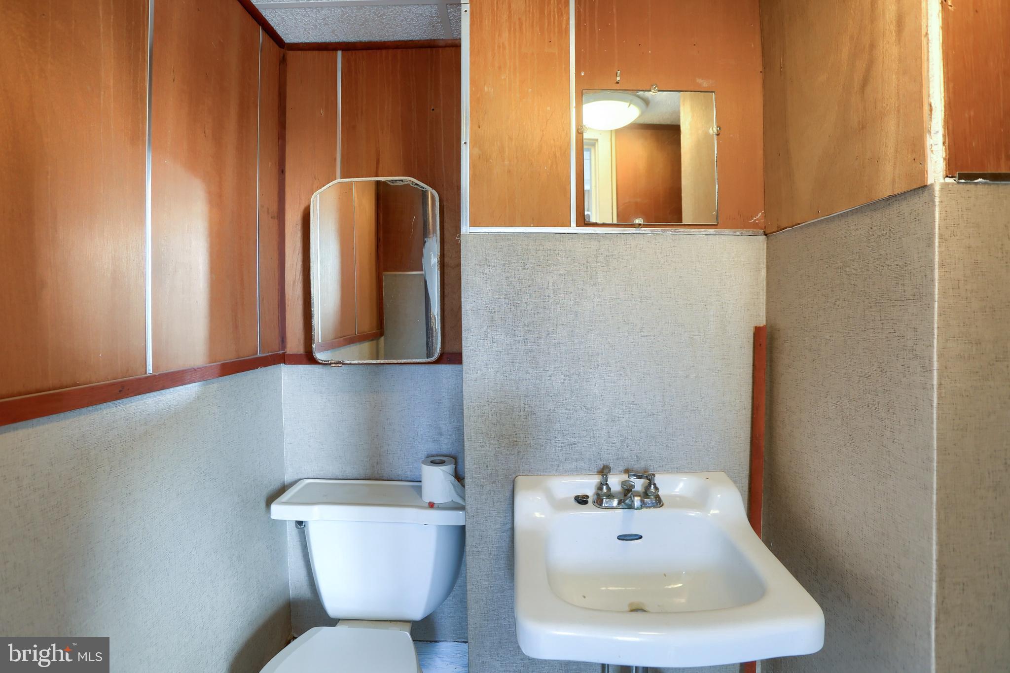 3095 Turkey Valley Road Mount Pleasant Mills, PA 17853 - Photo 40 of 55 a bathroom with a toilet sink and mirror