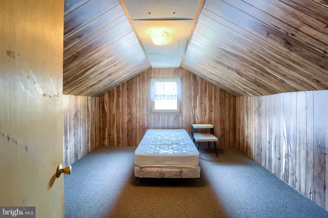 a view of a house with a big yard and large trees