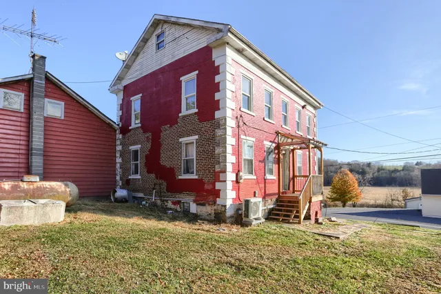 a view of a house with a yard and sitting area