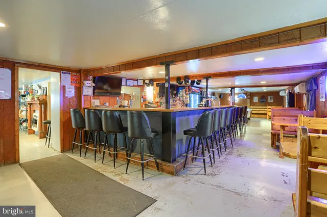 a dining room with furniture and a floor to ceiling window