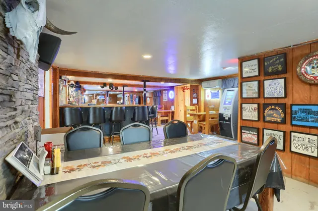 a dining room with furniture and a floor to ceiling window