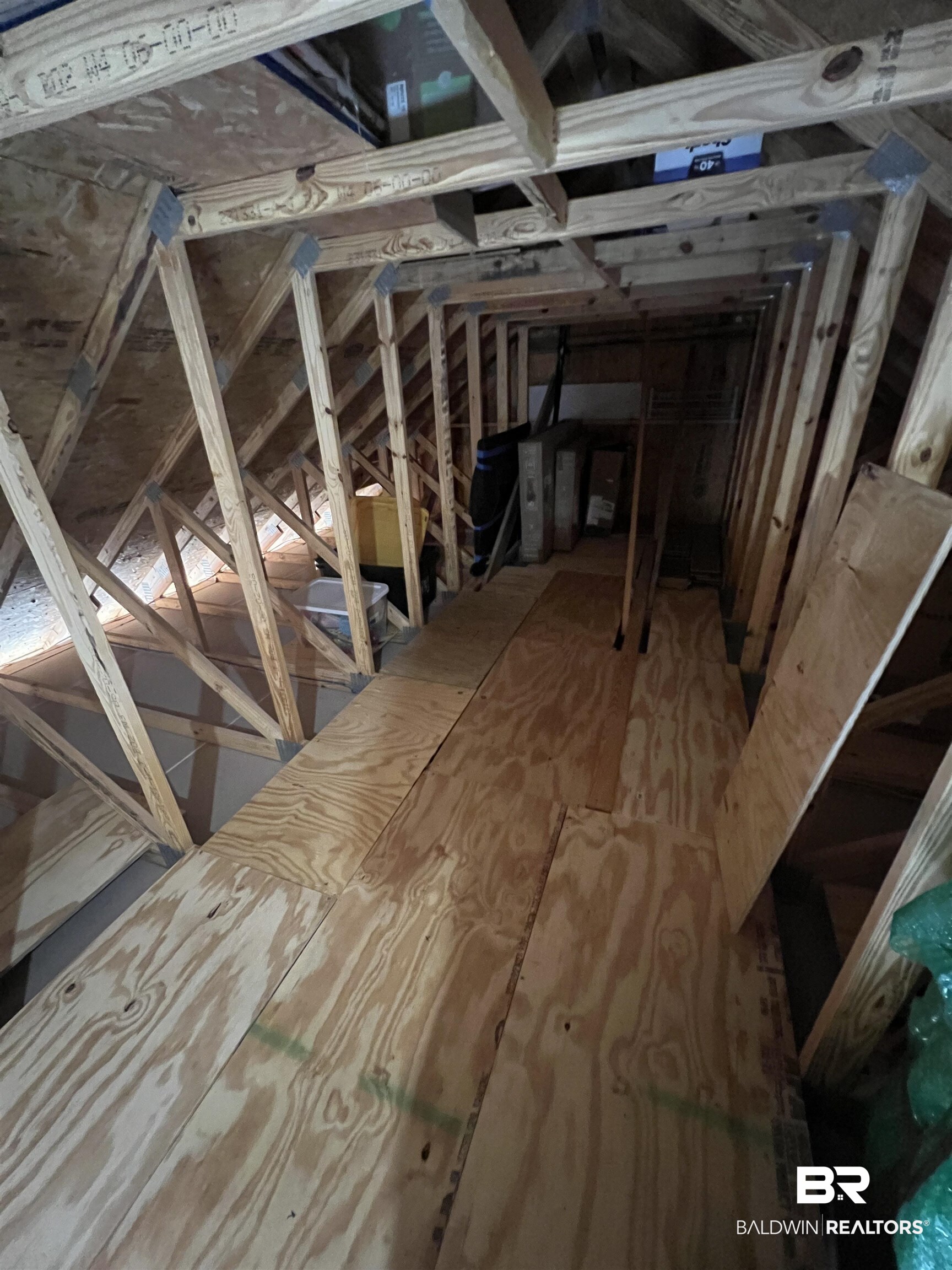 23523 Travis Stock Street Foley, AL 36535 - Photo 30 of 45 Attic space featuring exposed wood framing, partially floored with plywood panels