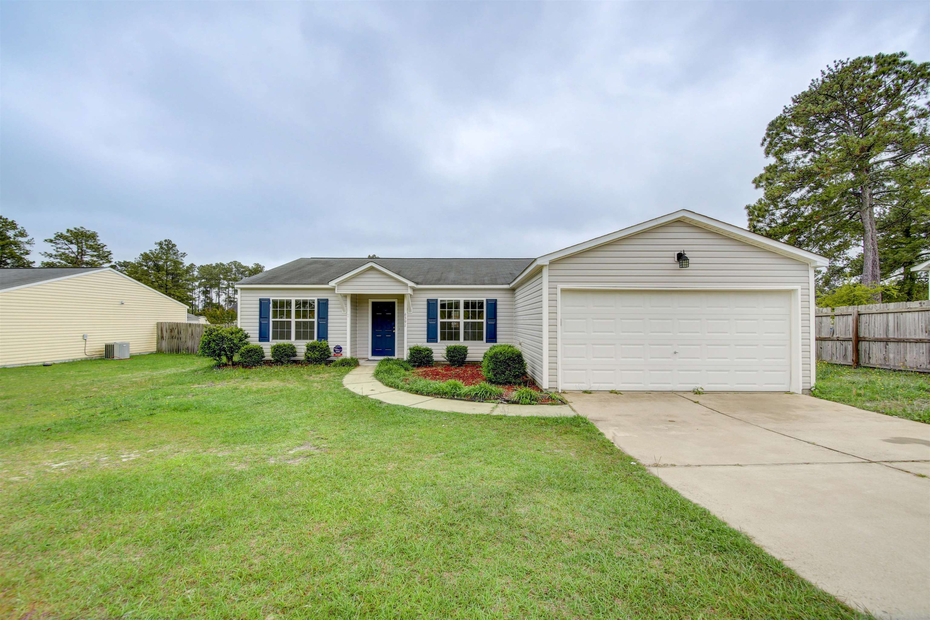 6391 Overhills Road Spring Lake, NC 28390 - Photo 1 of 15 a front view of house with yard and garage