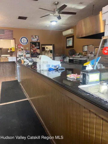 a kitchen with stainless steel appliances granite countertop a sink a stove counter space and cabinets