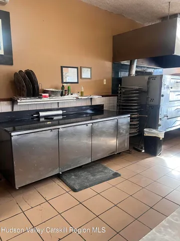 a kitchen view with granite countertop a sink and cabinets