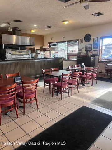 a living room with lots of furniture and kitchen view