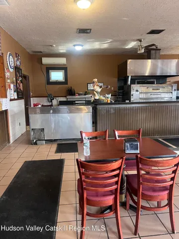 a kitchen with stainless steel appliances kitchen island granite countertop a sink and a black countertop