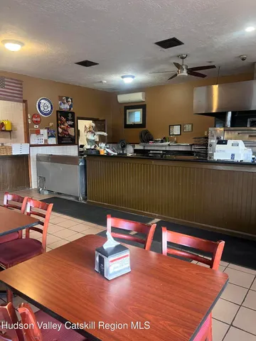 a kitchen with stainless steel appliances granite countertop a sink dishwasher and a refrigerator with wooden floor
