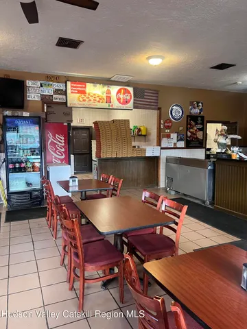 a outdoor kitchen with a table and chairs