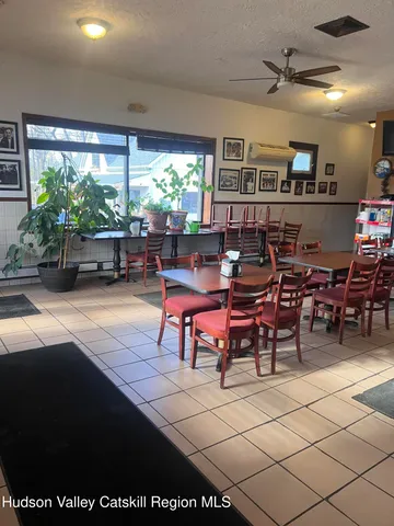 a living room with furniture a window and a flat screen tv
