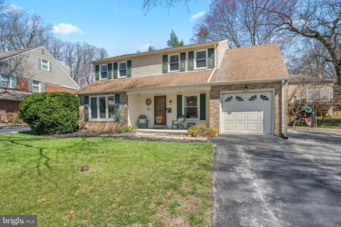 a front view of a house with yard patio and green space