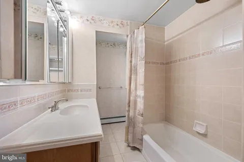 a bathroom with a sink a mirror and a bathtub