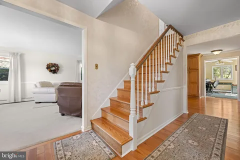a view of entryway and hall with wooden floor
