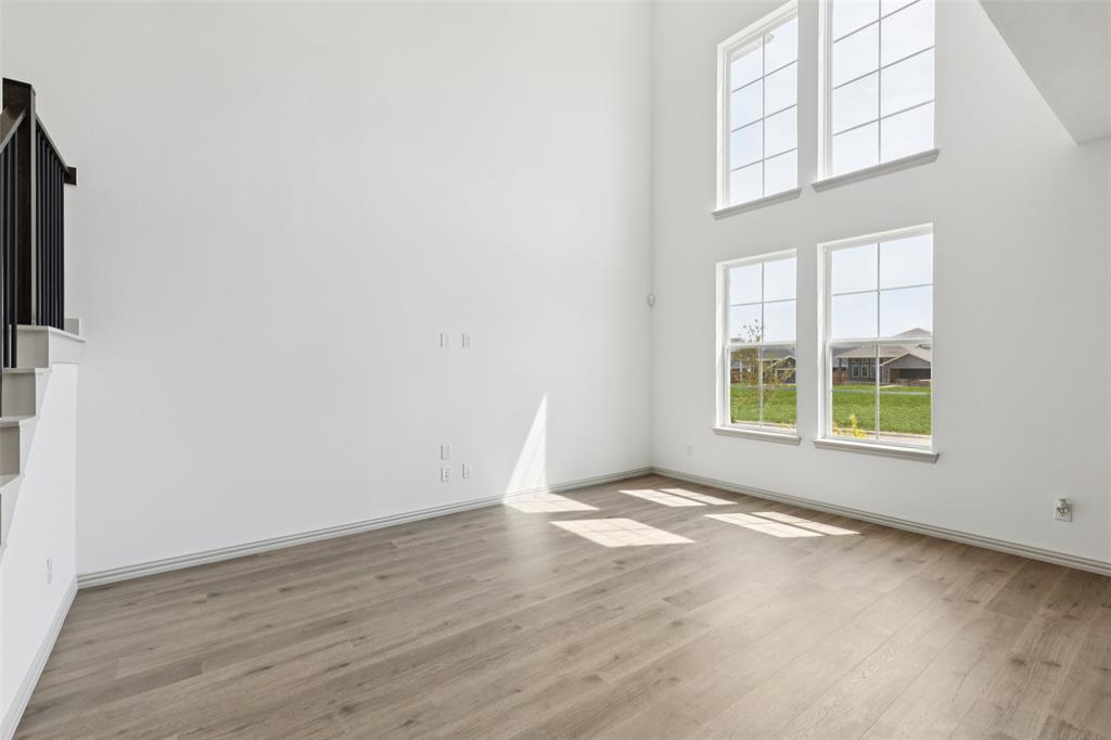 1029 Magdalena Way Midlothian, TX 76065 - Photo 5 of 16 Featuring volume windows in the family room, this beautiful home is filled with natural light.