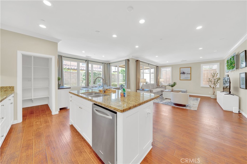 75 Gardenstone Path Irvine, CA 92620 - Photo 18 of 65 a open kitchen with stainless steel appliances granite countertop a lot of counter space and a wooden floor