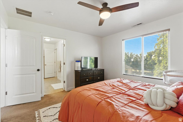 1187 Seraphim Court Layton, UT 84041 - Photo 8 of 18 Carpeted bedroom with ensuite bathroom and ceiling fan