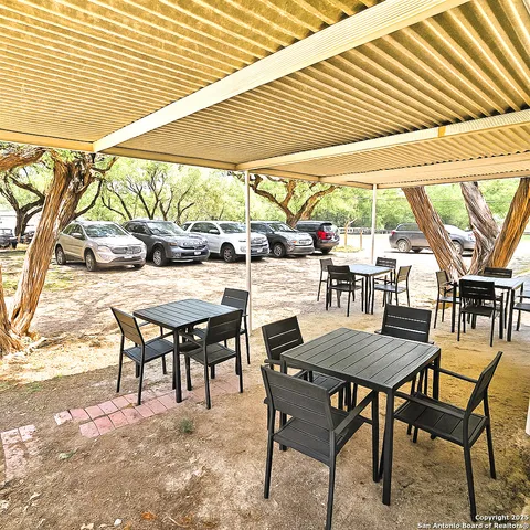 a backyard of a house with basket ball court