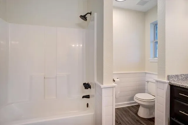 a bathroom with a toilet and a shower